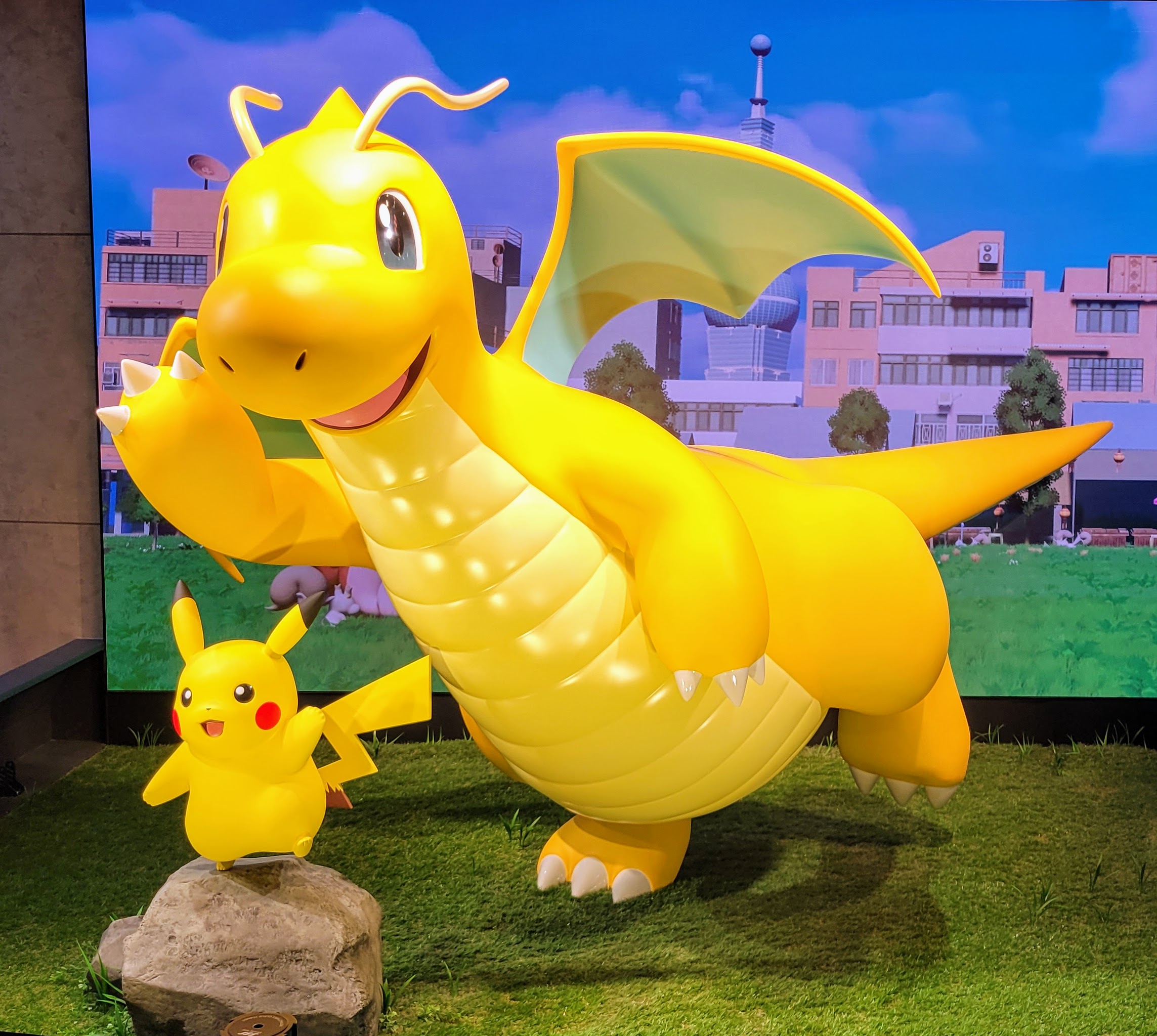 statues of pikachu and dragonite in the pokemon center in taipei